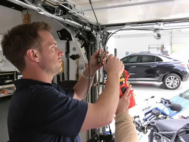 Lewisboro Garage Door Repair safety certified technician performing cable replacement in Lewisboro