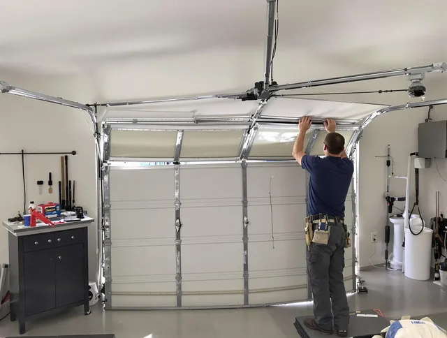 Lewisboro Garage Door Repair specialist performing precise section replacement on Lewisboro garage door